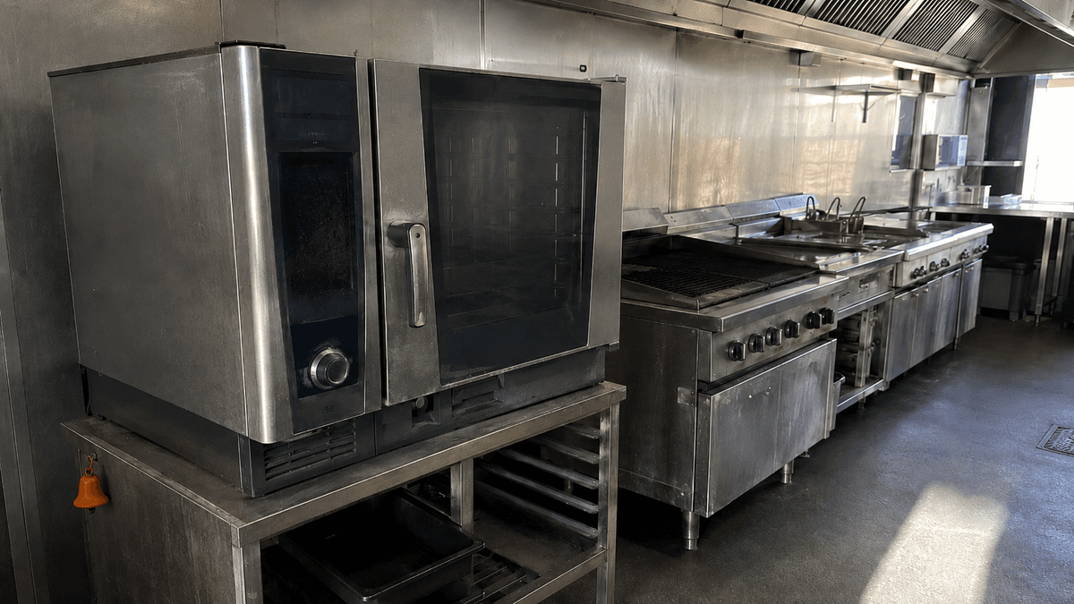 Closed chain pub kitchen line with combi oven and grills switched off