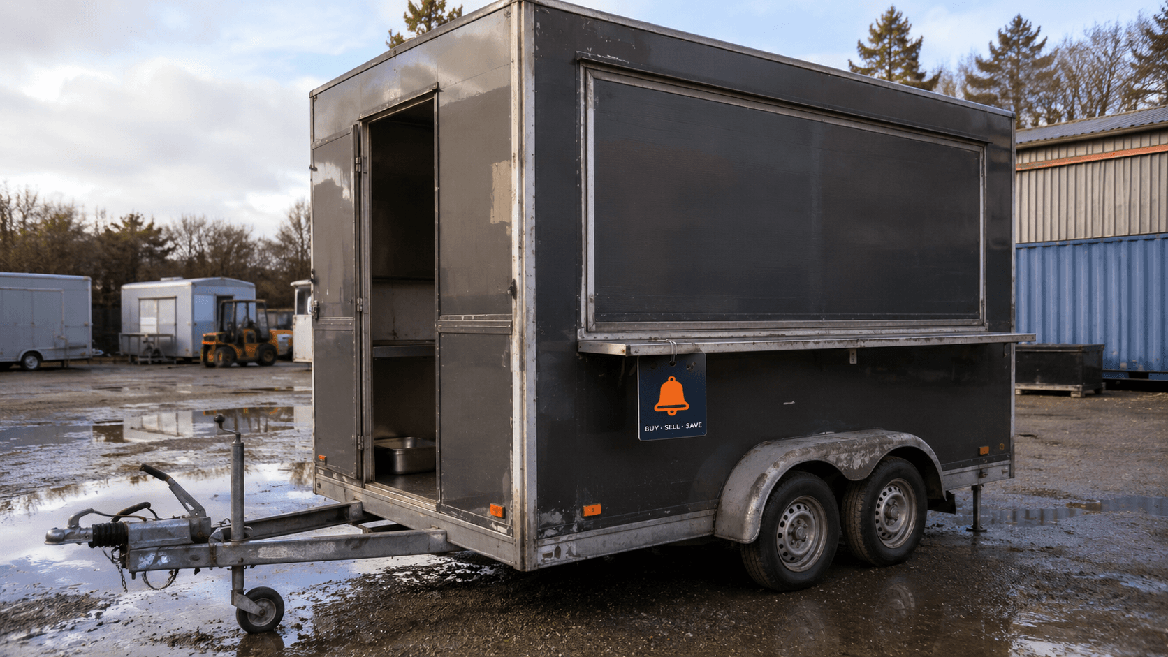 Used box catering trailer parked in a UK yard, showing the tow hitch, wheel arch and serving hatch ahead of a buyer's checklist.